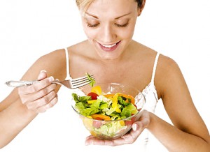 Young Woman Eating a Salad --- Image by © Michael A. Keller/Corbis